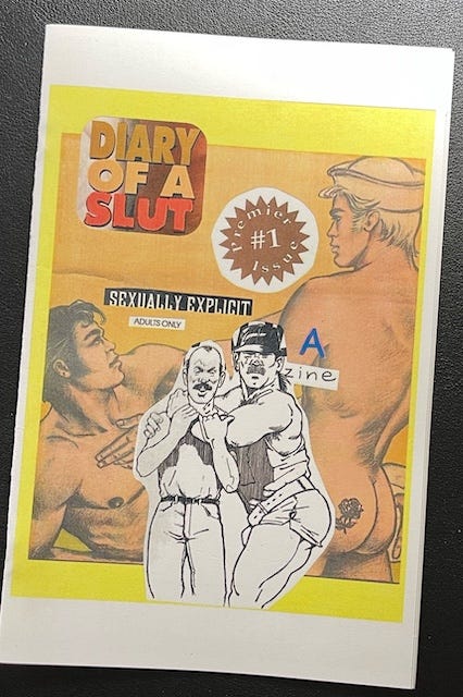 Alt text: Cover of a handmade zine titled Diary of a Slut #1. The background features a collage of vintage erotic art depicting muscular, mostly nude men in stylized, homoerotic poses, labeled "SEXUALLY EXPLICIT – Adults Only." Over this backdrop is a black-and-white cut-out illustration of two men, one hugging the other from behind in a suggestive pose. The word “zine” is handwritten in blue over a paper label with the word “A” typed before it. The overall aesthetic combines retro gay erotica with DIY zine culture, evoking themes of queer sexuality, parody, and reclamation.