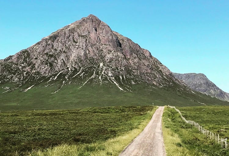a path leading to a mountain in the scottish highlands