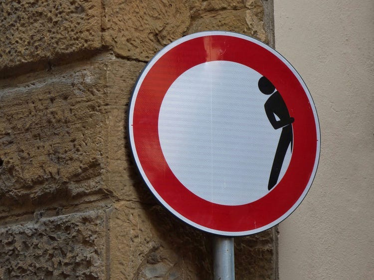 hiding behind a sign hiding behind a sign