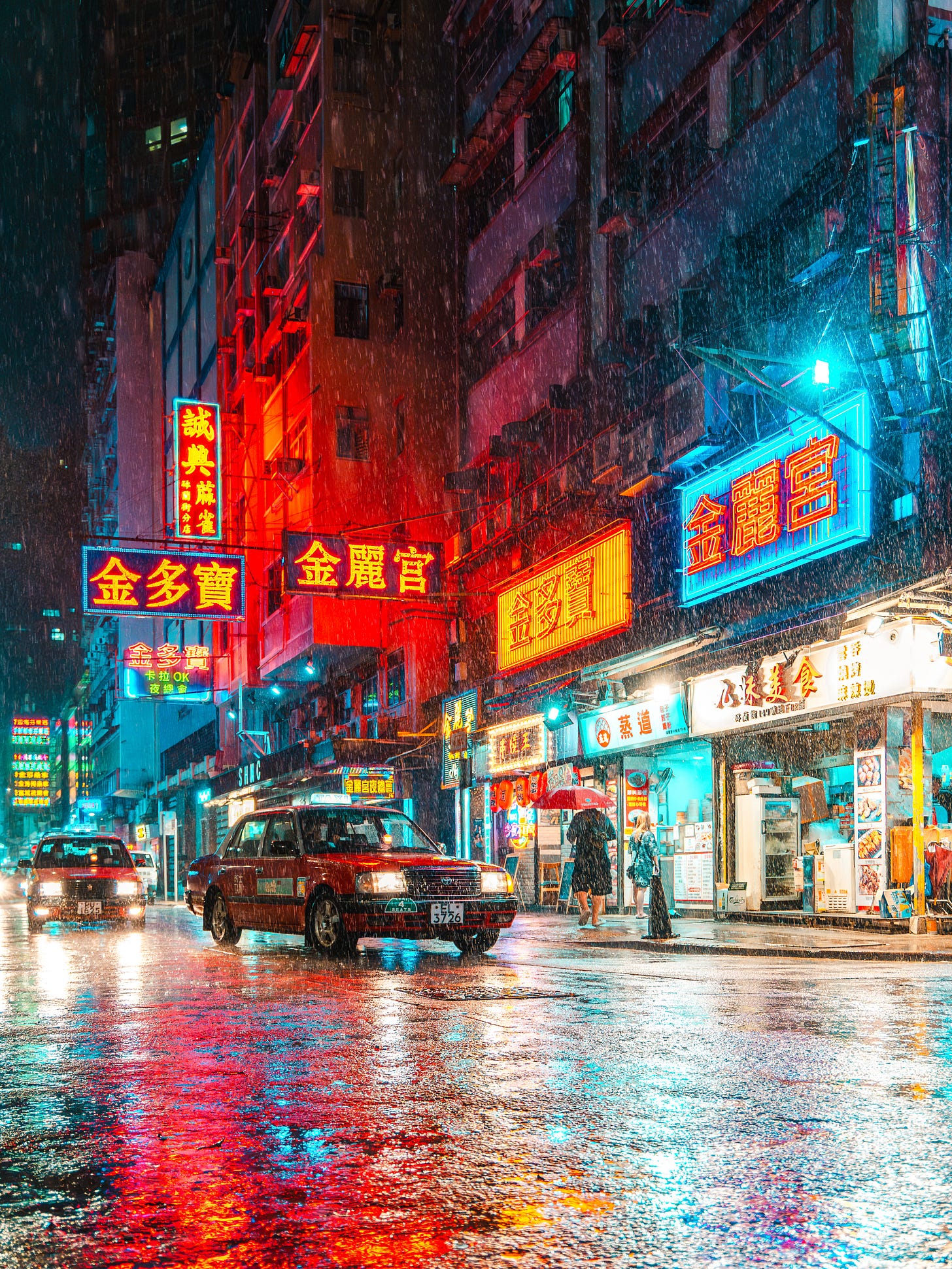 Neon signs on Portland Street in Mong Kok, Hong Kong, reflected on wet pavement during rain Neon signs on Portland Street in Mong Kok, Hong Kong, reflected on wet pavement during rain