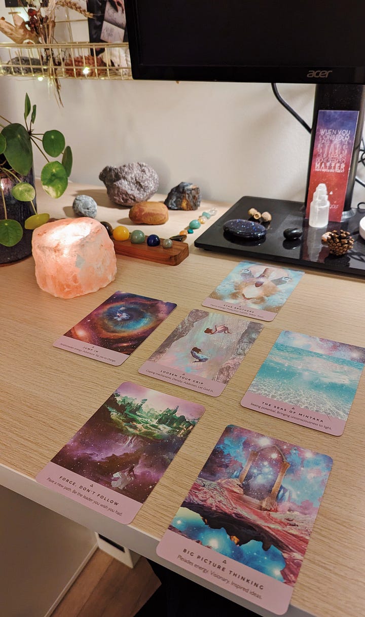 The image on the left shows six Starseed oracle cards laid out on a desk with a glowing salt candle and various crystals, the second is the same, but with seven cards from the Spirit Animal Deck