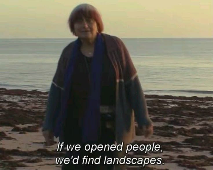 This may contain: a woman standing on top of a sandy beach next to the ocean with a quote