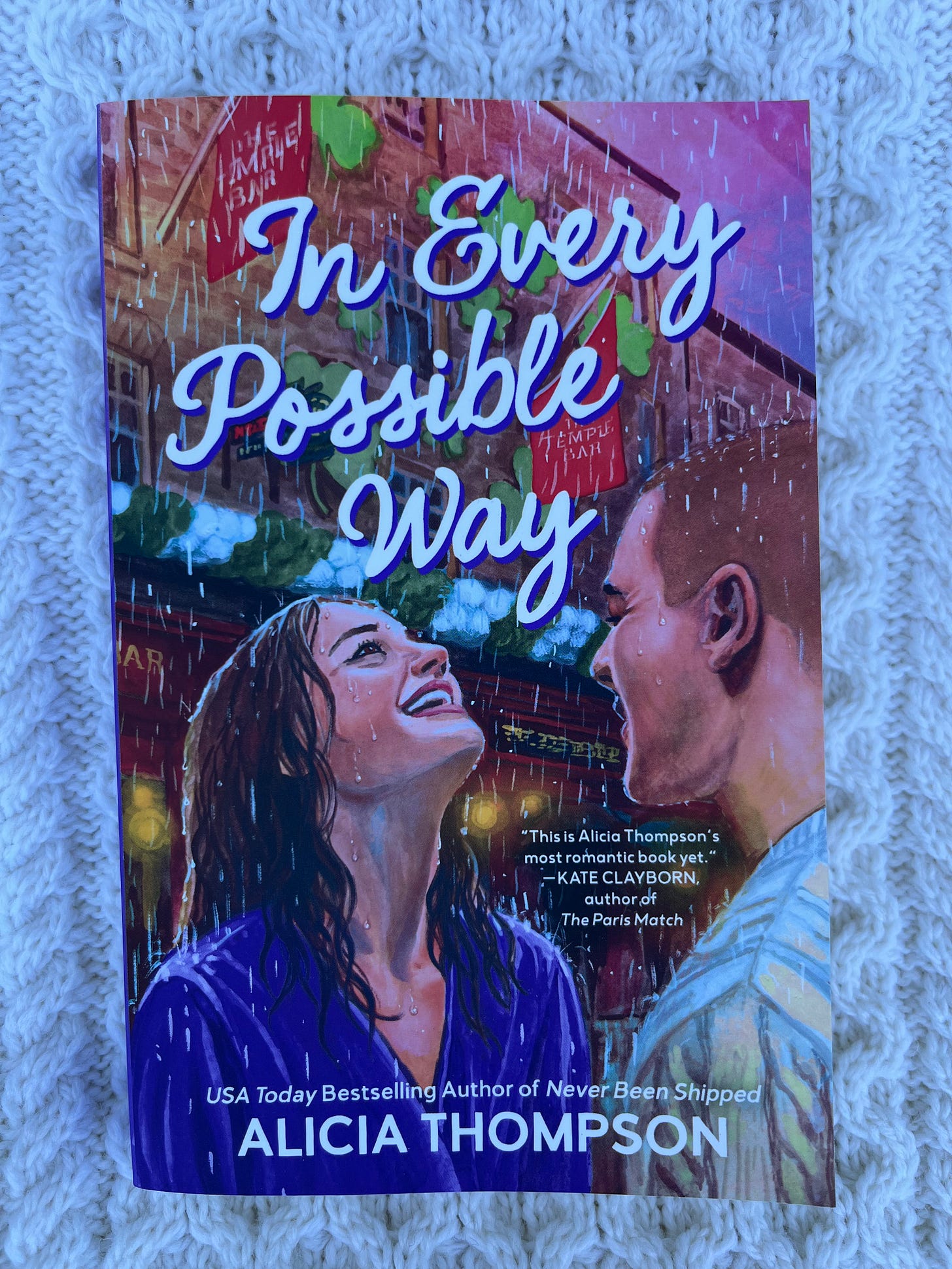 photo of IN EVERY POSSIBLE WAY by Alicia Thompson on top of a cream-colored cableknit sweater