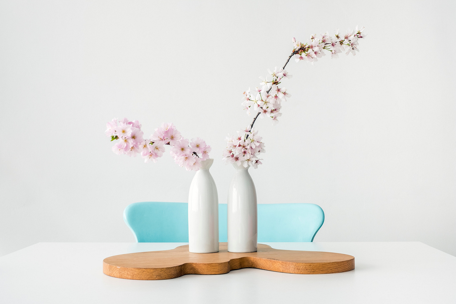 Clean, white dining table with flowers