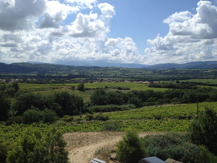 Alain Viret next to a cosmic pipe, amphora, grenache grapes in stony soil, the view from the winery
