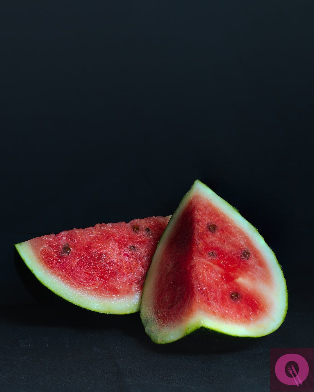 sliced watermelon on black background