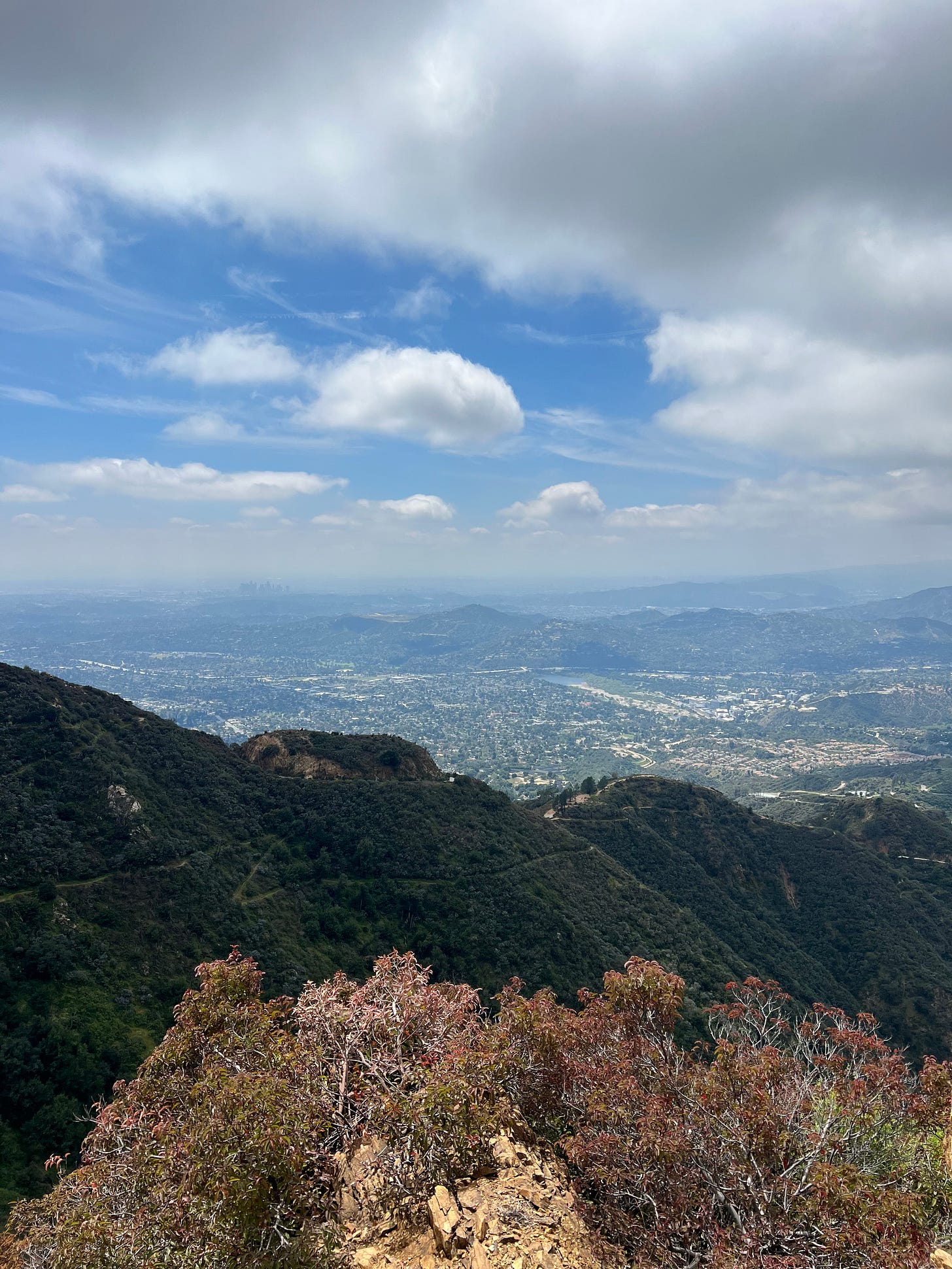 mountains with a blue sky and clouds above