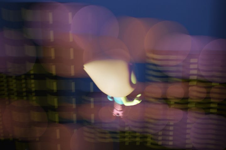 First photo: A photo of a Pearl figurine against an illustration of a dark blurry cityscape. Second photo: A screenshot from the animated show Steven Universe of Pearl against a luminous blurry cityscape.
