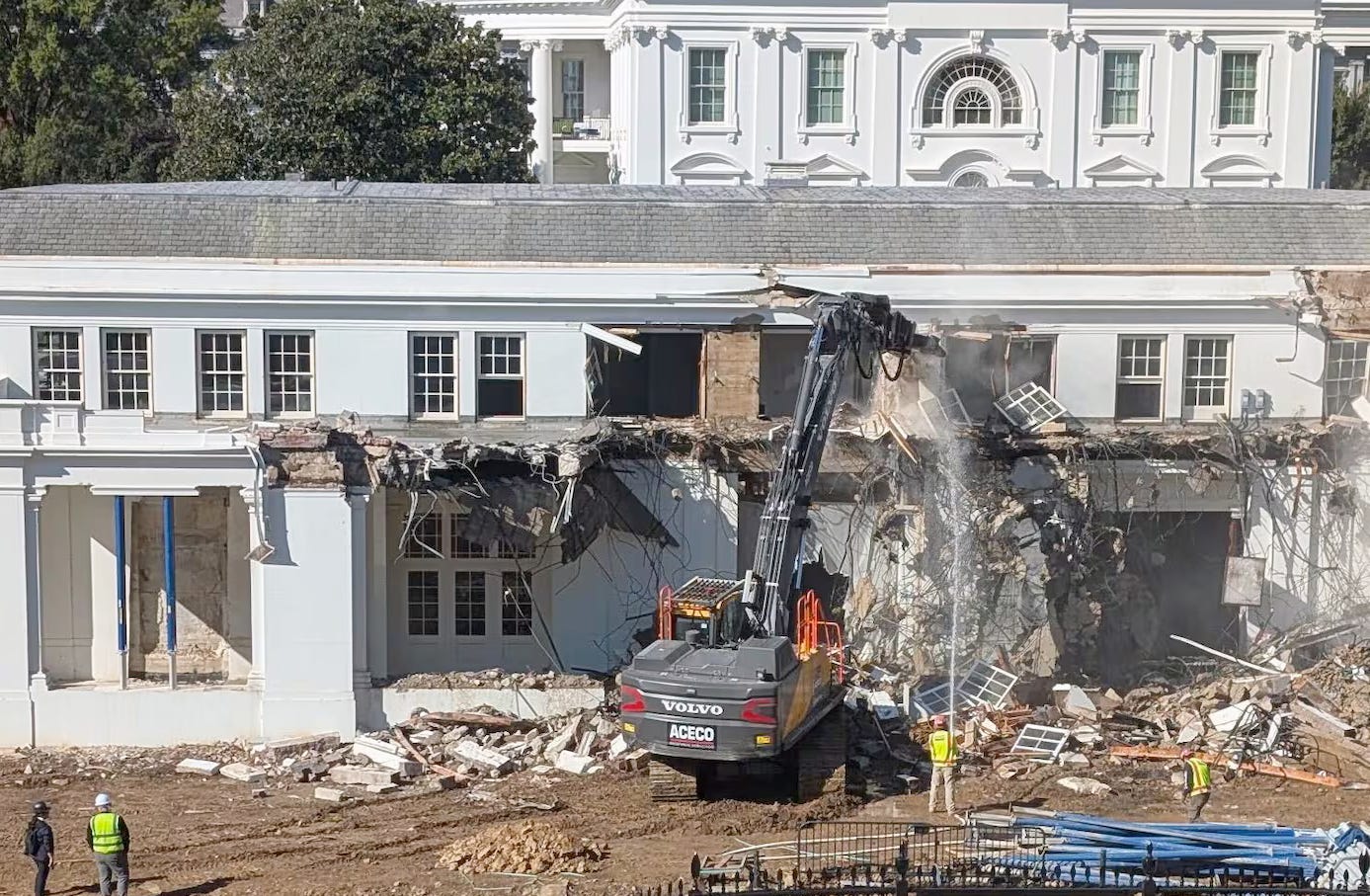 The White House with a big hole in it and construction crews all around.