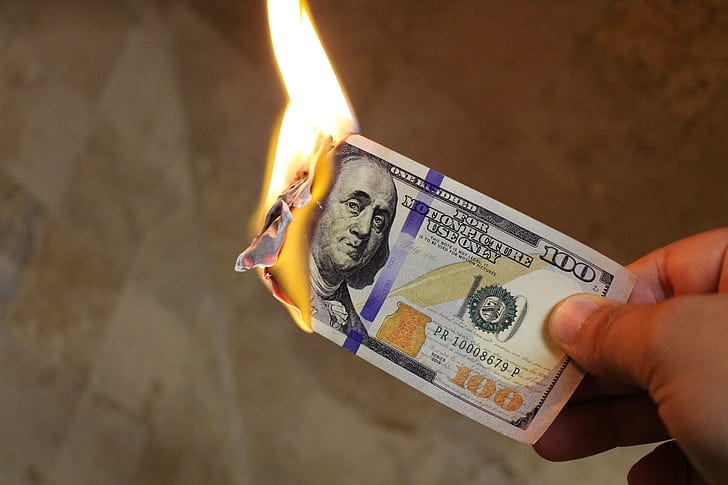 person holding 100 U.S. Dollar banknote person holding 100 U.S. Dollar banknote