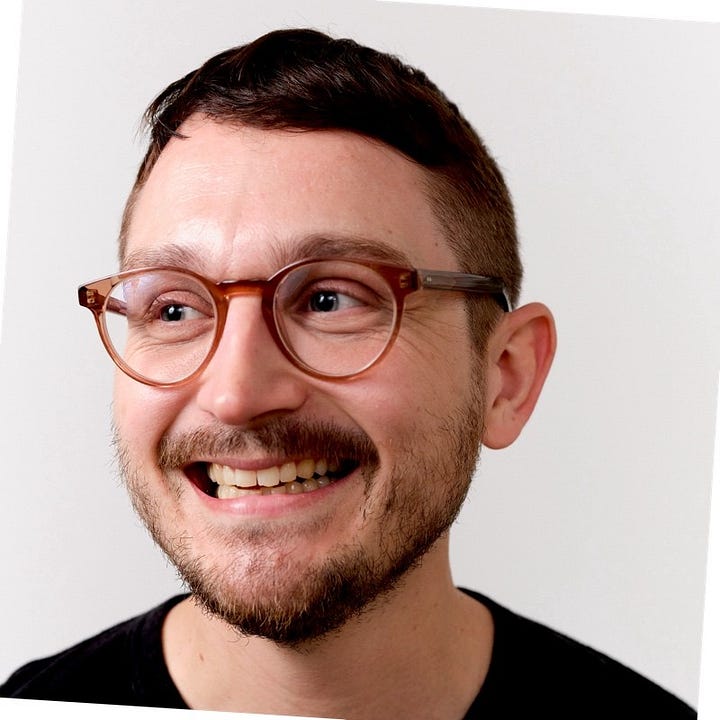 portrait of thom rutter a man in glasses with short dark hair