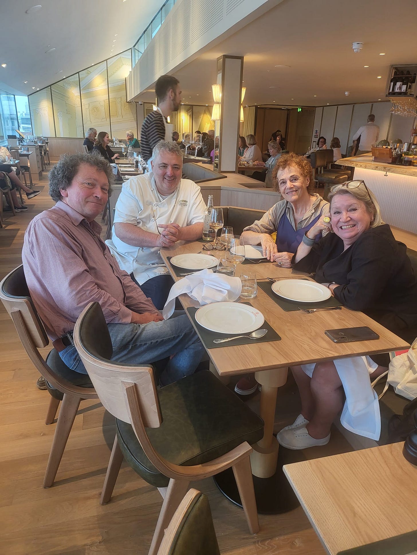 A group of people sitting at a table

Description automatically generated