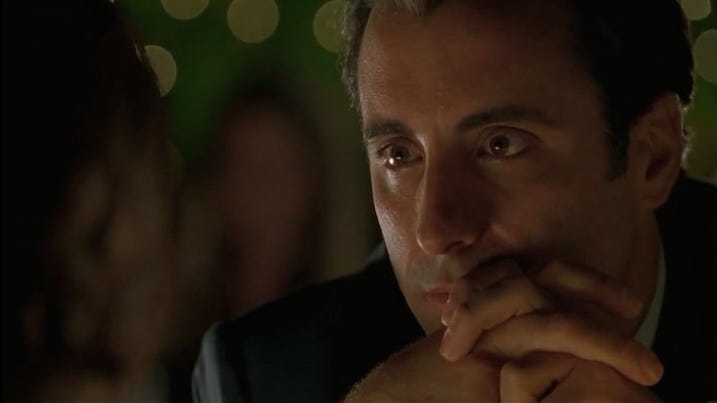 Jimmy's Stare: Andy Garcia’s character, Jimmy the Saint, stares longingly at someone off-camera with romantic lights softly blurred in the background.