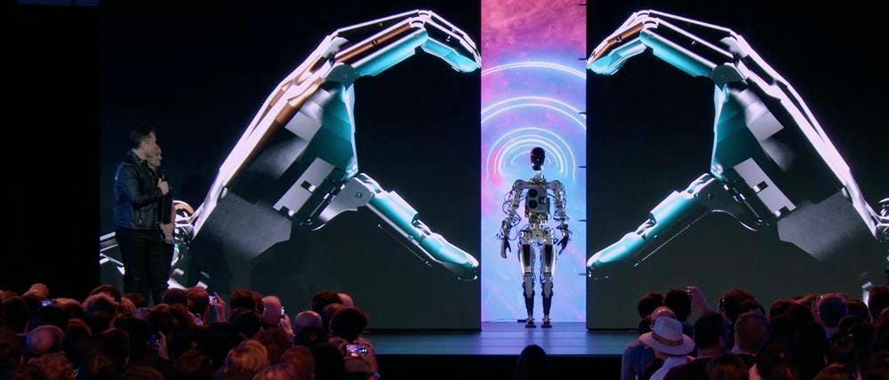Elon Musk presenting Tesla Optimus humanoid robot on stage Elon Musk presenting Tesla Optimus humanoid robot on stage