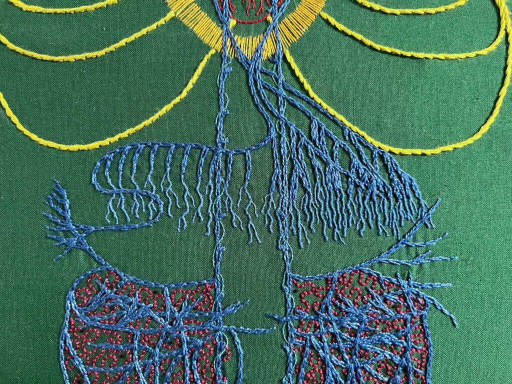 A close up of an embroidery focused on the diaphragm of the vagus nerve stitched in blue chain stitch in perlé thread on dark green cotton. Spiralling around the very straight main vagus is single strand whipped back stitch in electric blue. The bottom of a red heart with some yellow lines around it are above the diaphram. The nerve endings in the diaphragm area are lengthened with one and two strand whipped back stitch. The abdomen has many layers of crossing wavy lines. Some roiling burgundy back stitch in burgundy perlé thread is between the blue. Sparse tiny black French knots are stitched in the gut area. 