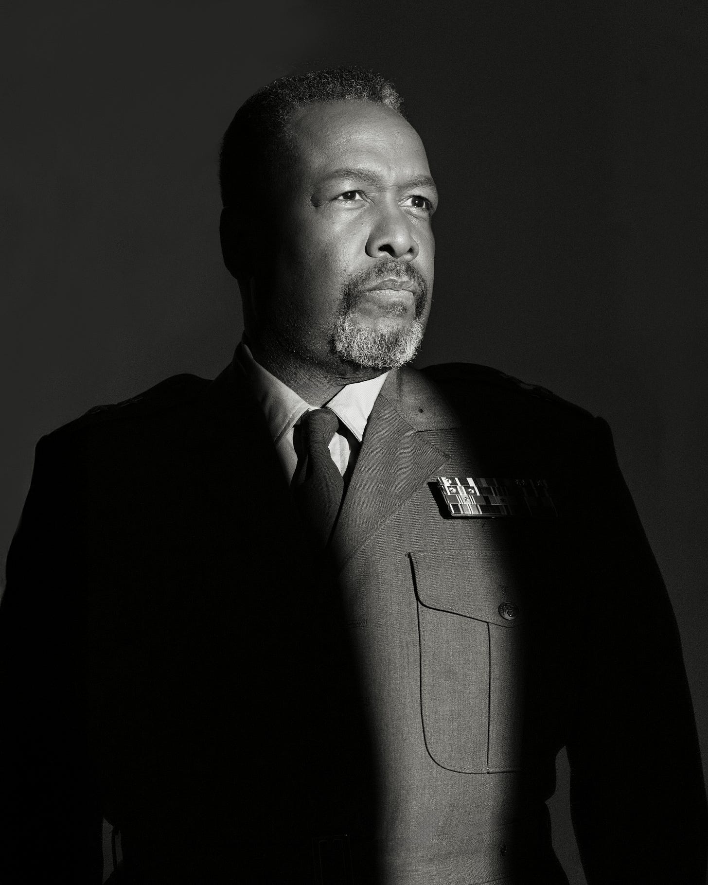 Wendell Pierce in costume for Othello, shown in three-quarter view beneath dramatic shadow.
