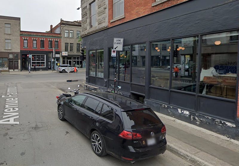A Montreal street before a green treatment. The street is filled with concrete and no shade.