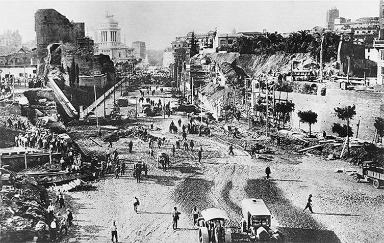 A black-and-white photograph of the demolition operations
