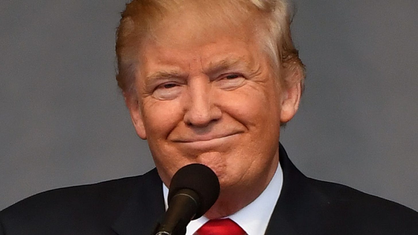 A person in a suit and tie

Description automatically generated with medium confidence