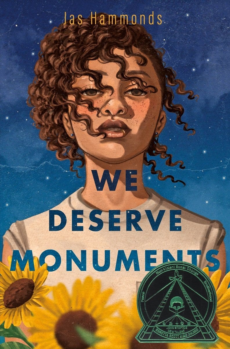 We Deserve Monuments Book Cover. A brown skinned femme with curly hair looking at the viewer with sun flowers below them and the stars in the sky behind them.