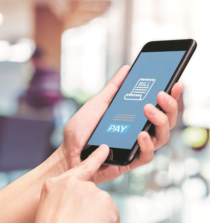 Student managing tuition payments using Payoneer on mobile device.