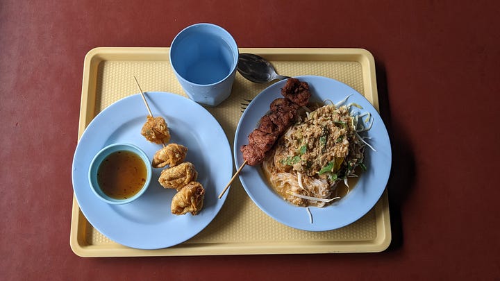 curry lunch tray and scene of people in cafeteria