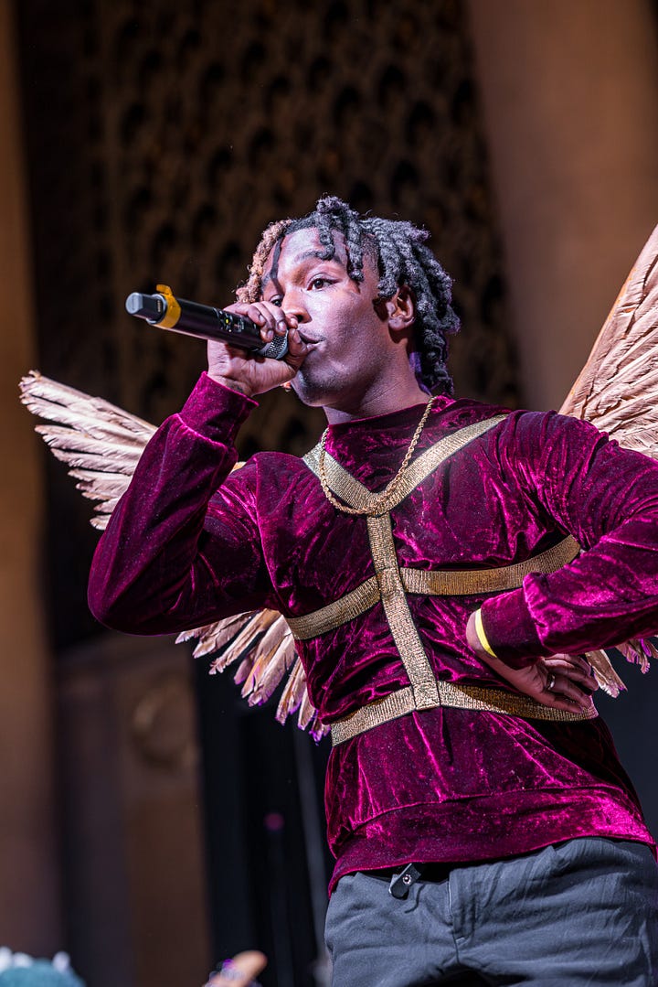 BAJSH aka Bless Angel Jesus Saved Him, performing live on stage with wings.