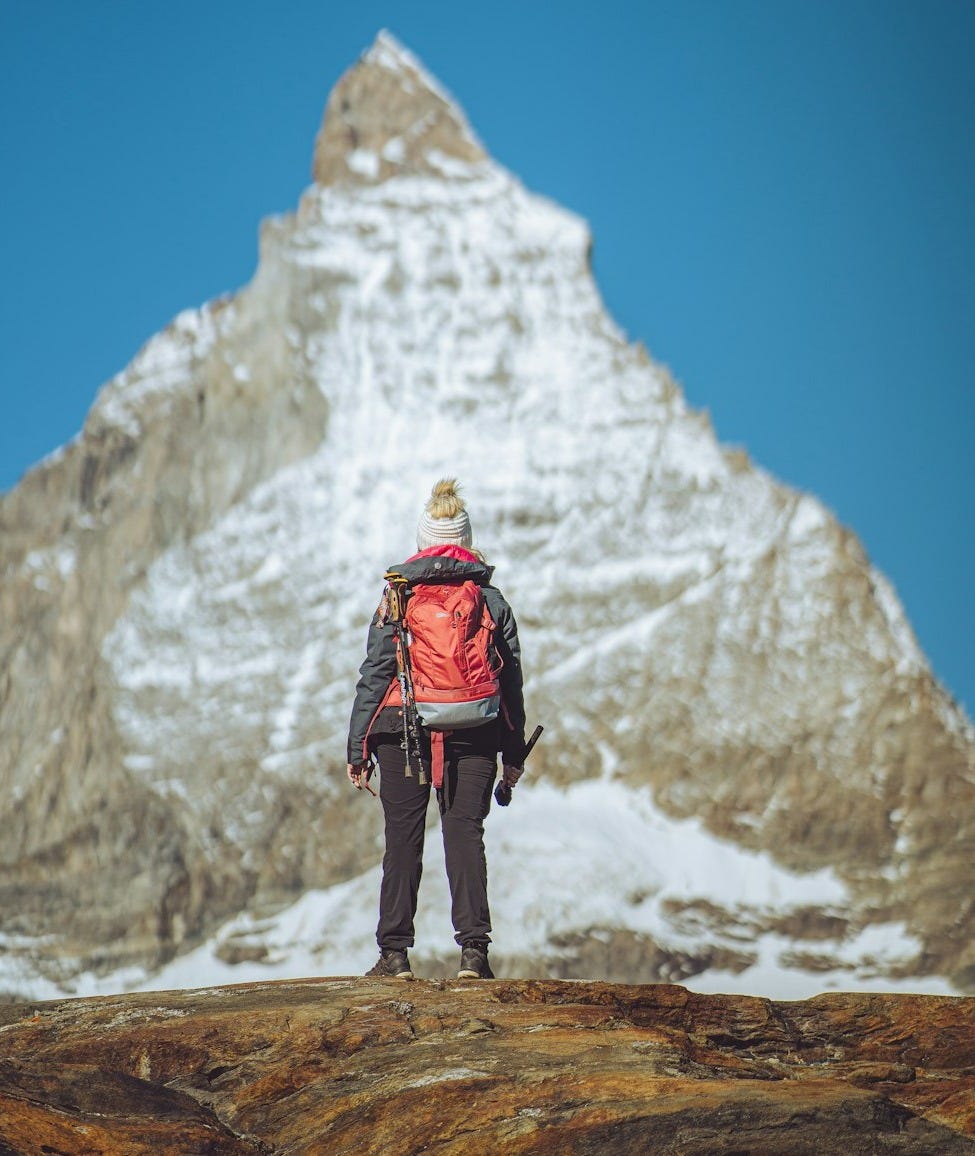 a man standing on top of a snow covered mountain