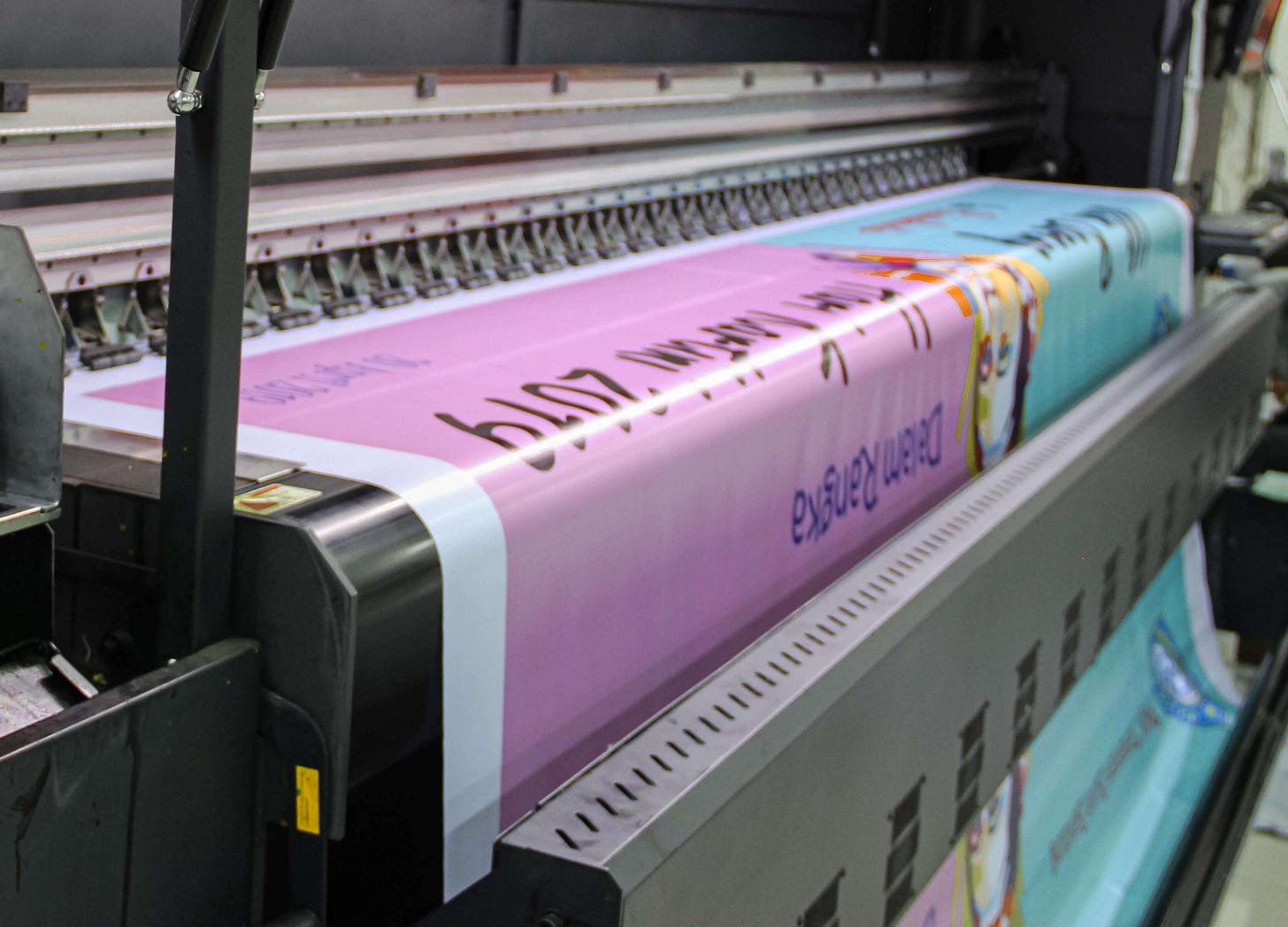 Large banner being printed by a wide-format printer