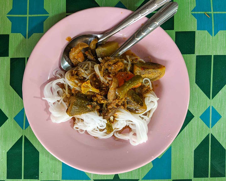 overhead shot of a plate of noodles topped with chunky curry and vegetables