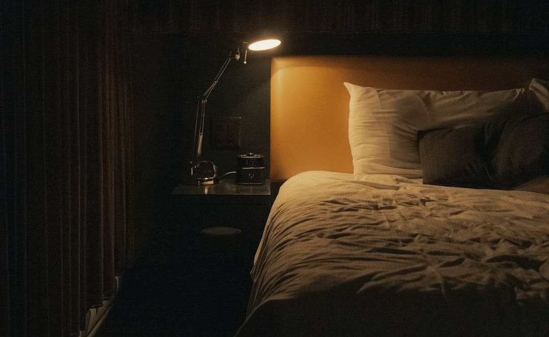 turned on study lamp beside bed turned on study lamp beside bed