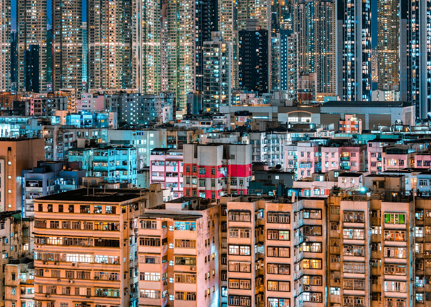 Dense residential towers in Sham Shui Po, Hong Kong, lit up at blue hour Dense residential towers in Sham Shui Po, Hong Kong, lit up at blue hour