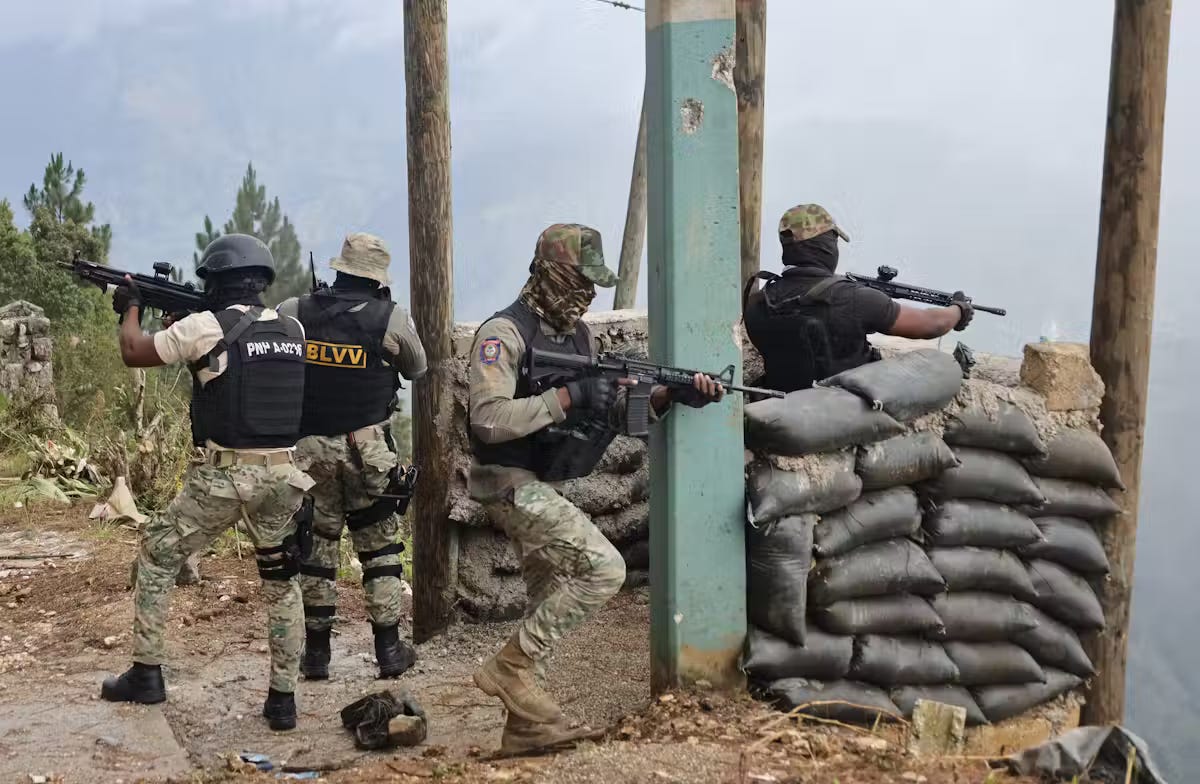 Haitian policemen fire their weapons after an attack by an armed gang in Kenscoff, a town near Port-au-Prince, in August 2025.