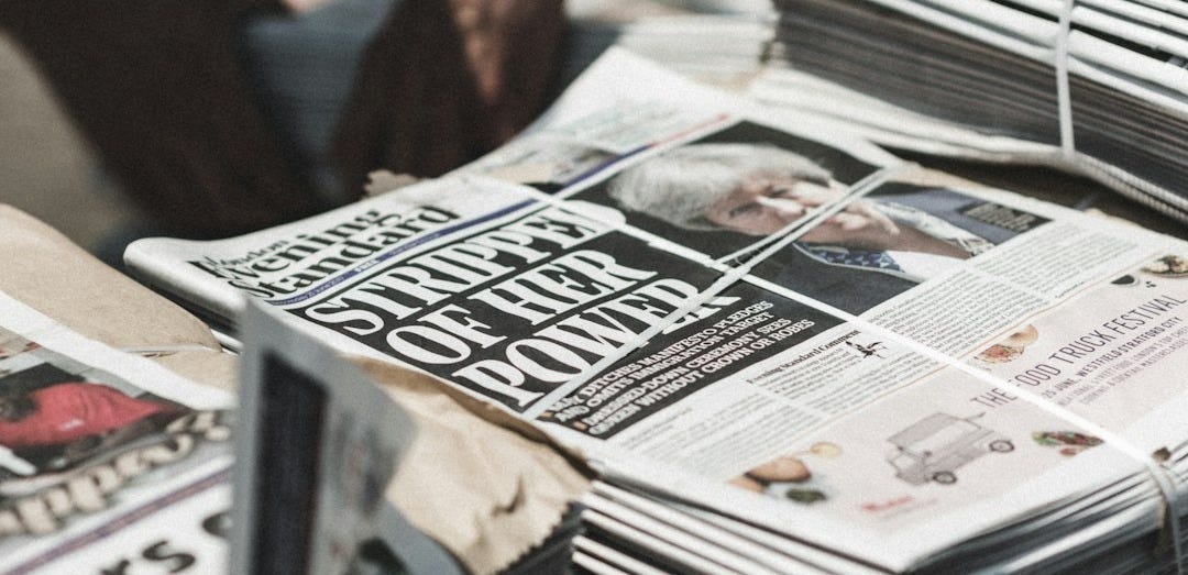 shallow focus photography of piles of newspapers