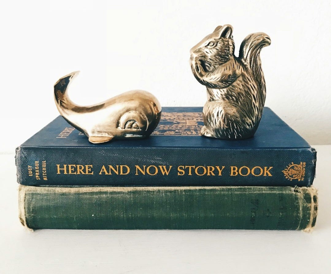 gray and white rabbit figurine on green book gray and white rabbit figurine on green book