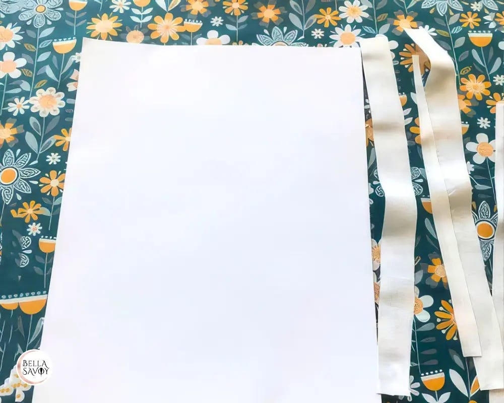 fabric with 8.5x11 inch sticker and edges trimmed to sticker size.