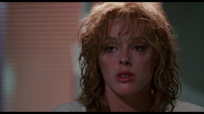 Brigitte Nielsen as Ingrid in Cobra 4K UHD – Close-up of Nielsen with wet hair and tired expression, from the Arrow Video remastered version.