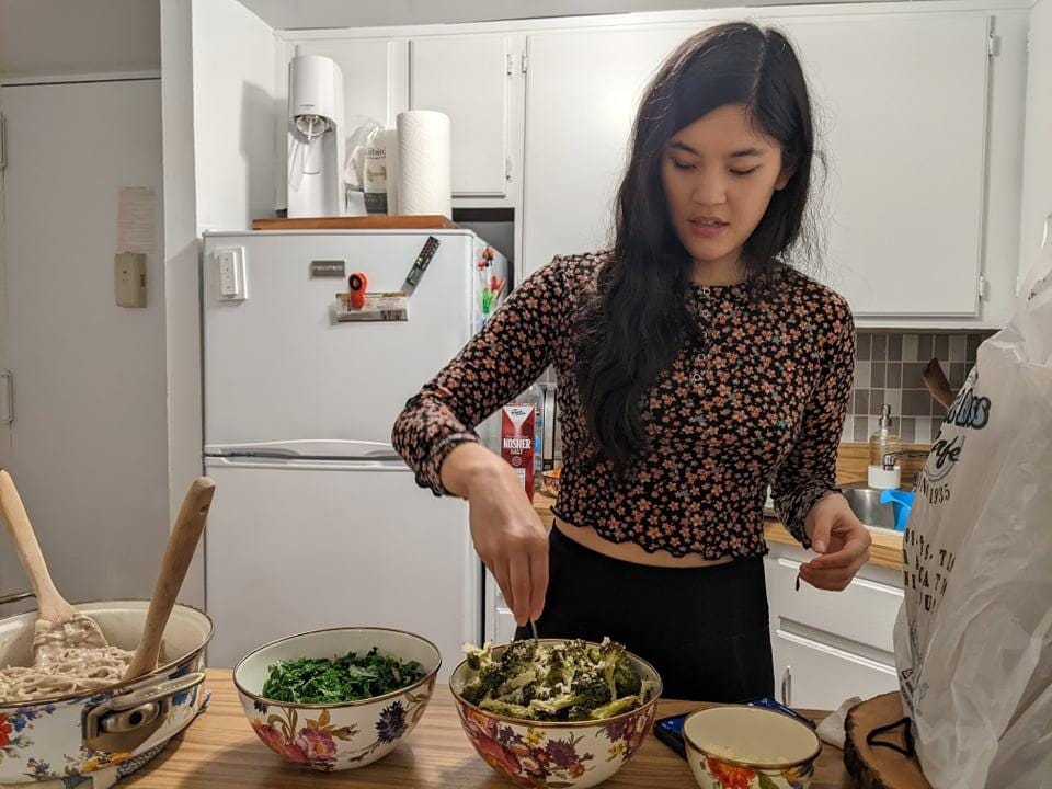 A person cooking in a kitchen

Description automatically generated with medium confidence
