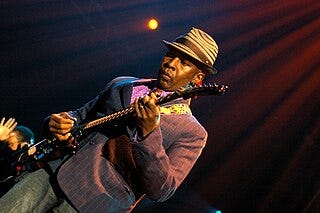 Photographs of Living Colour album covers and the band performing live