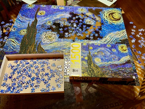 a jigsaw of the vincent van gogh painting starry starry night in various levels of completion. the final photo shows the four duplicate pieces included next to where they matched the puzzle.