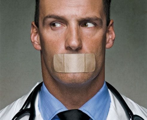 Doctor with band aid over his mouth Doctor with band aid over his mouth
