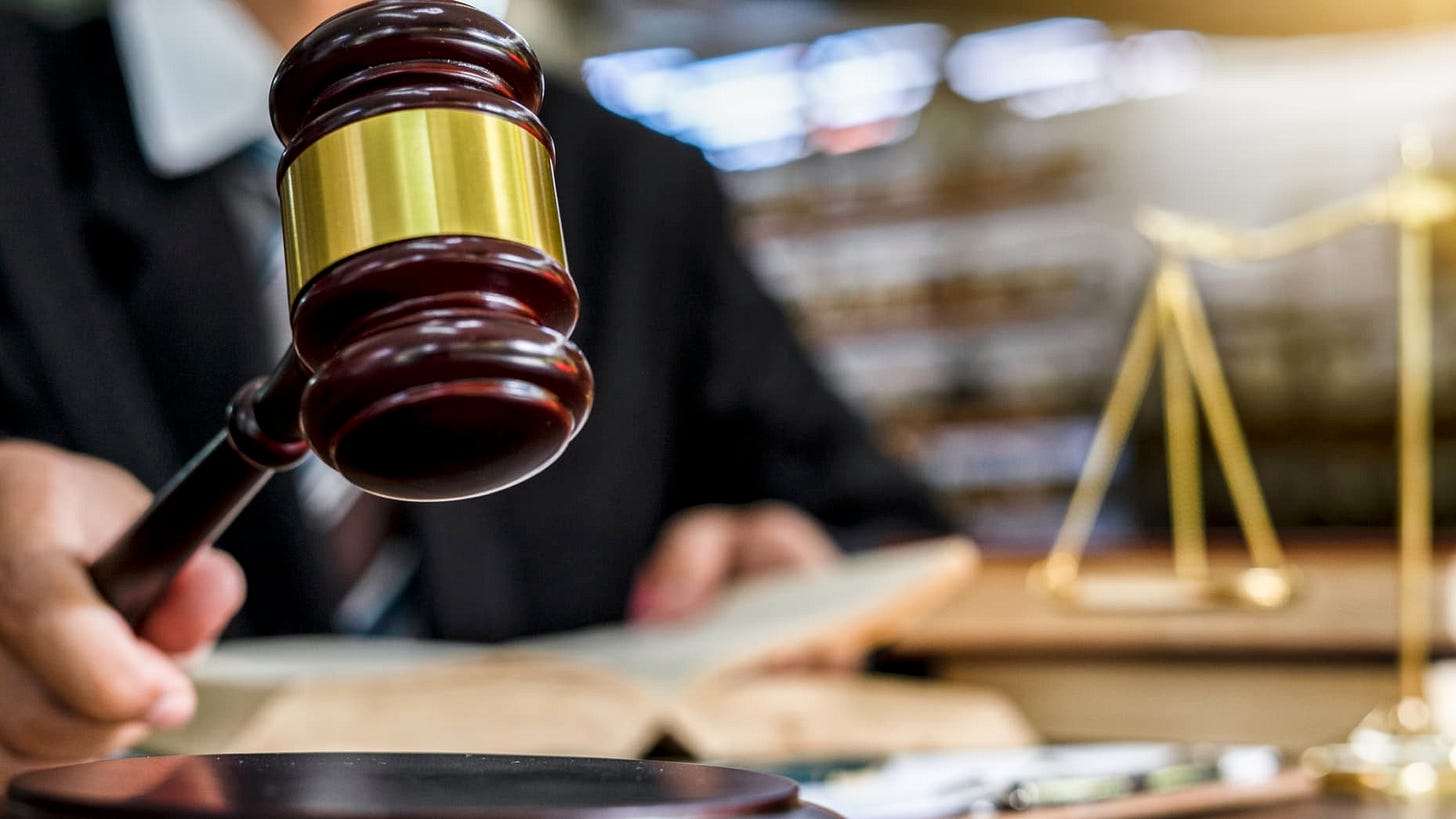Close up of judge holding a gavel.