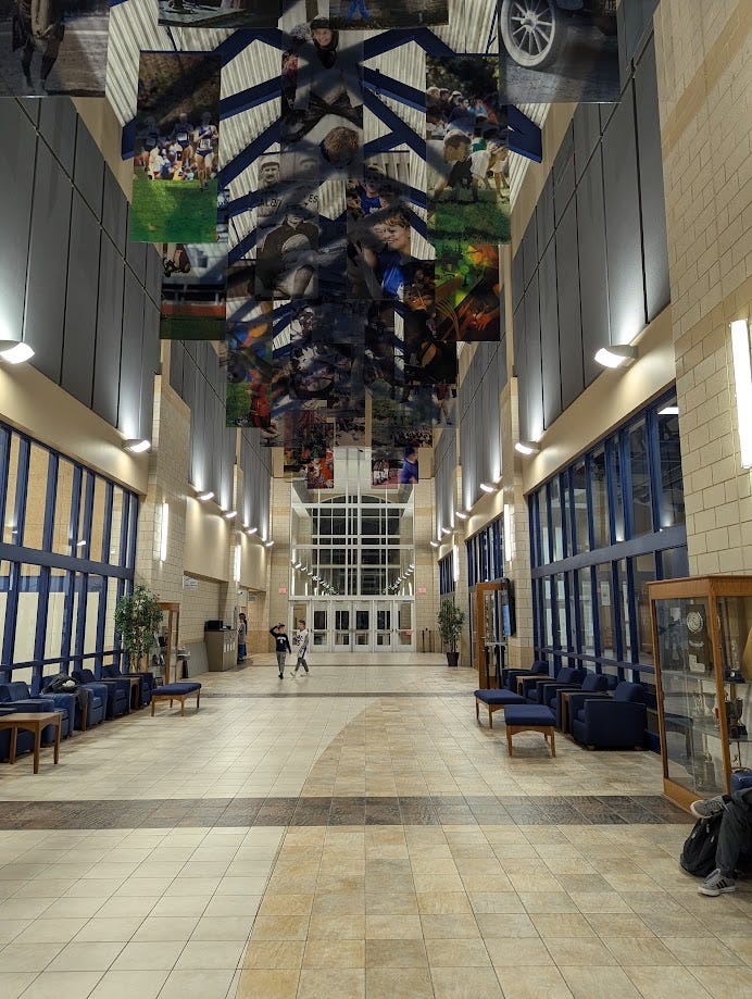 The Leonard Center atrium, a long, cavernous hallway with banners draped from the ceiling