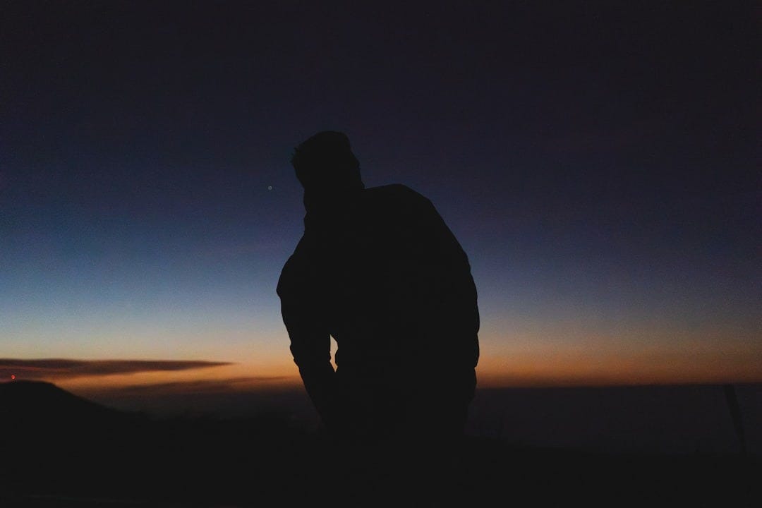 Silhouette of a person against a twilight sky. Silhouette of a person against a twilight sky.