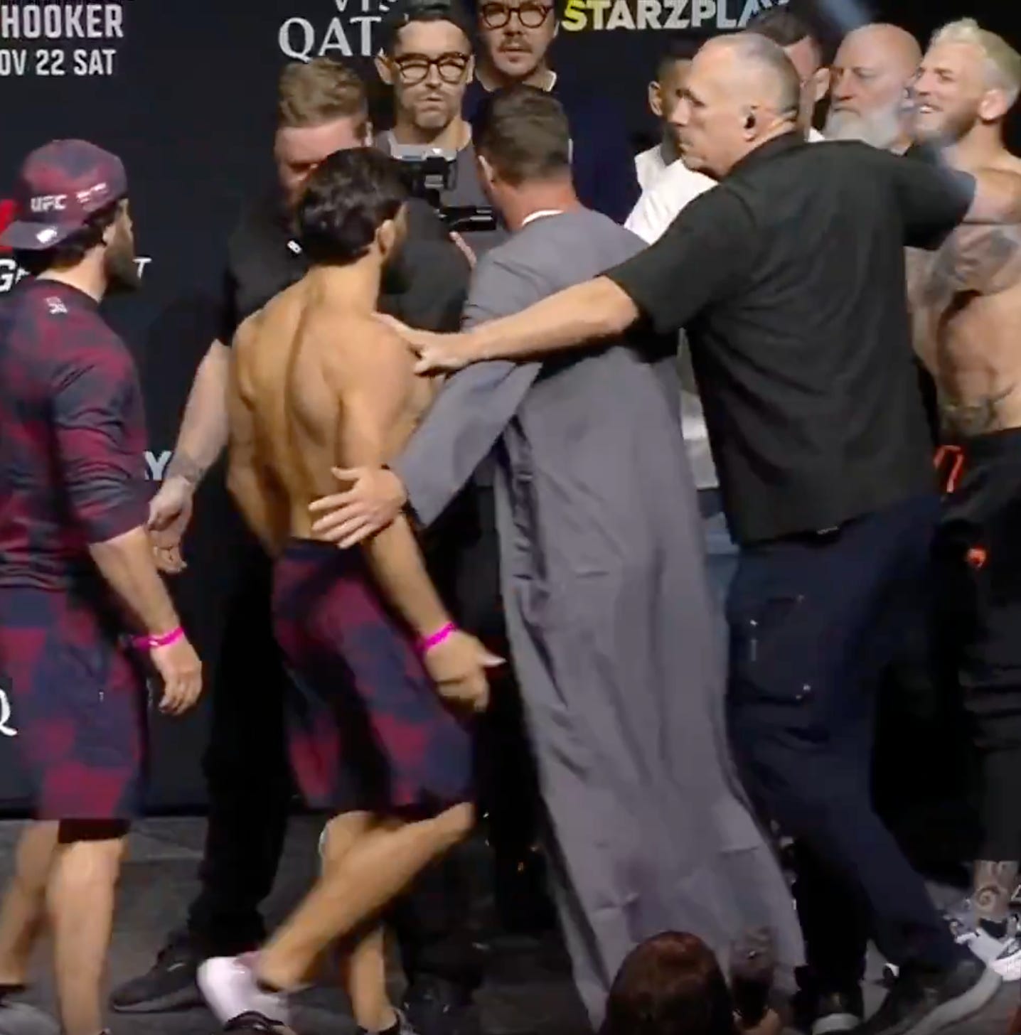 UFC Qatar main eventers Arman Tsarukyan and Dan Hooker are separated by UFC matchmaker Sean Sheldy whil UFC underboss Hunter Campbell fades into the background