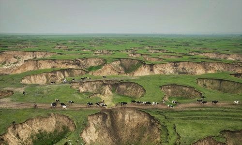 Grassland at a coal mine in Baorixile, Inner Mongolia, is dotted with pits left by ruthless exploration over the past few decades. Photo: Lu Guang, courtesy of Greenpeace Grassland at a coal mine in Baorixile, Inner Mongolia, is dotted with pits left by ruthless exploration over the past few decades. Photo: Lu Guang, courtesy of Greenpeace