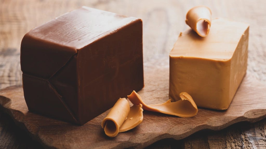 A brown and white cubes of chocolate
Description automatically generated A brown and white cubes of chocolate
Description automatically generated