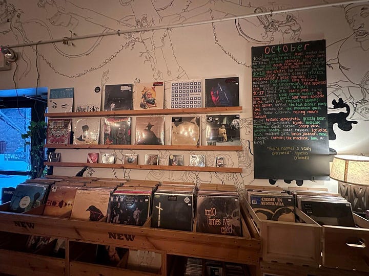 L to R: color photograph of several shelves in a record store; photograph of blair ebony smith  at a turn table. behind blair are shelves with records, magazines, and photographs.