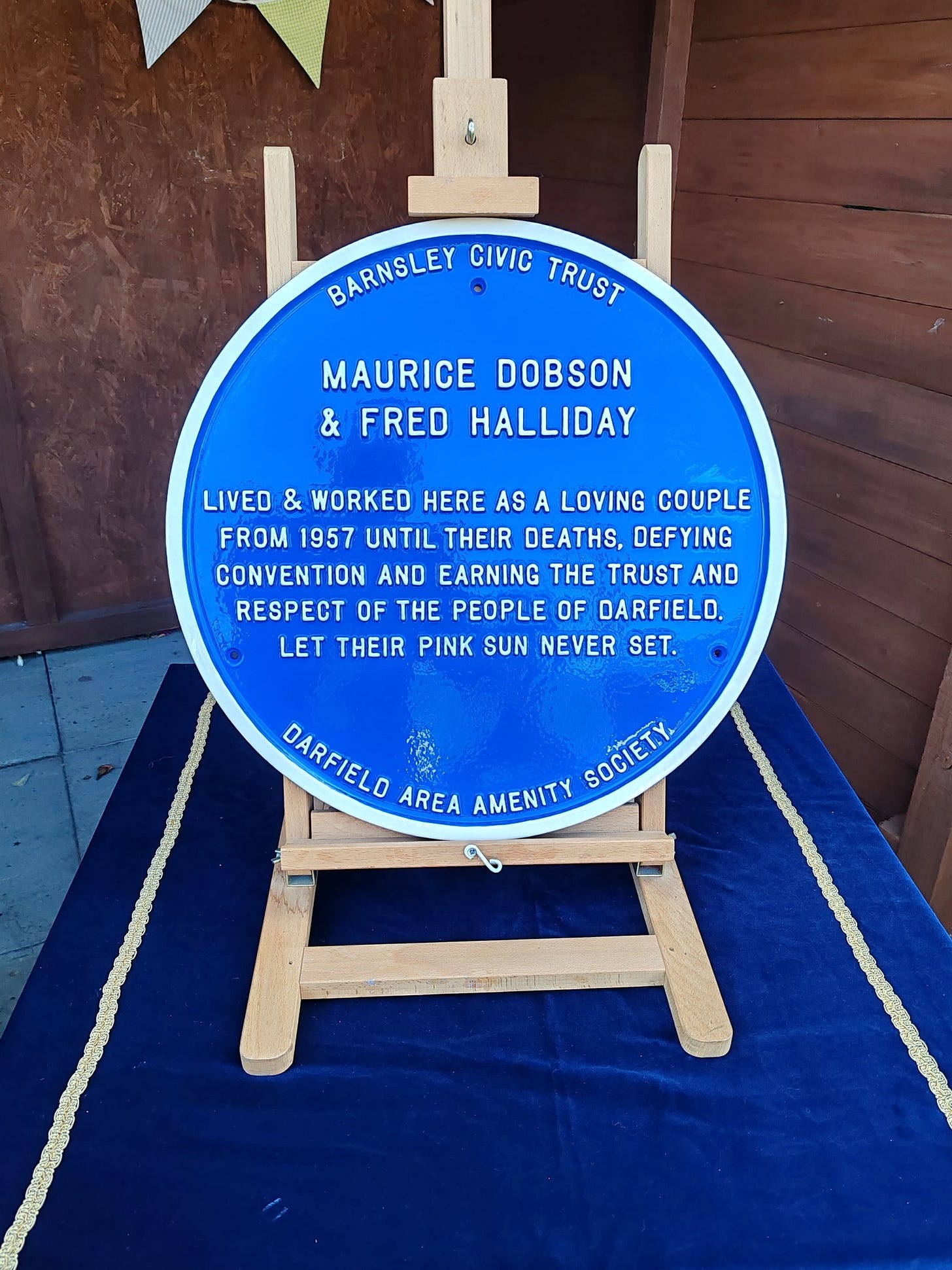 May be an image of text that says 'BARNSLEY CIVIC TRUST MAURICE DOBSON & FRED HALLIDAY LIVEO & WORKED HERE AS A LOVING COUPLE FROM 1957 UNTIL THEIR DEATHS, DEFYING CONVENTION AND EARNING THE TRUST AND RESPECT OF THE PEOPLE OF DARFIELO. LET THEIR PINK SUN NEVER SET. DARFIELO DARFIELO AREA AMENITY SOCIET. SOCIErt a' May be an image of text that says 'BARNSLEY CIVIC TRUST MAURICE DOBSON & FRED HALLIDAY LIVEO & WORKED HERE AS A LOVING COUPLE FROM 1957 UNTIL THEIR DEATHS, DEFYING CONVENTION AND EARNING THE TRUST AND RESPECT OF THE PEOPLE OF DARFIELO. LET THEIR PINK SUN NEVER SET. DARFIELO DARFIELO AREA AMENITY SOCIET. SOCIErt a'