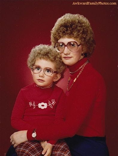 This may contain: an older woman and young child wearing glasses